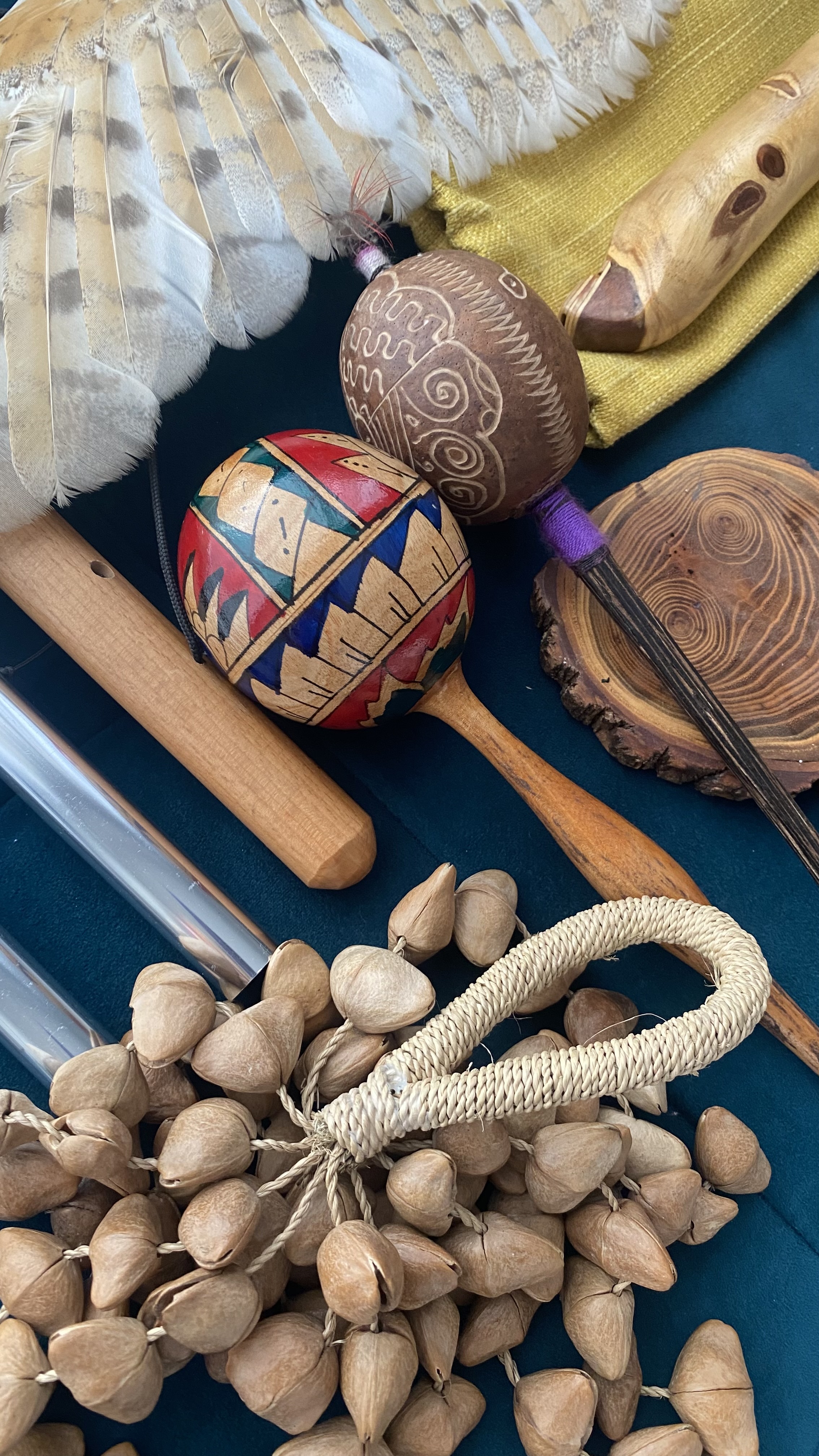 A collection of sound instruments — maracas, rainstick, feather fan